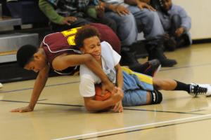 Mariner's Demetris Price battles a Milford defender for a loose ball in the Vikings' 39-26 win over the Bucs. BY DAN COOK