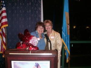 Eastern Sussex Republican Club member Priscilla Clark presents Club President Mary Spicer with a gift for organizing the annual Lincoln Day Dinner. BY KARA NUZBACK