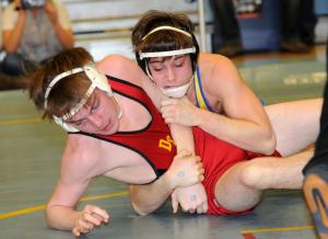 Caesar Rodney's Kaleb LeMaire works for the pin over Glasgow's Chris Holloway in the first round of the DIAA state tournament. BY DAN COOK