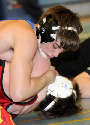 Caesar Rodney's Kaleb LeMaire works for the pin over Glasgow's Chris Holloway in the first round of the DIAA state tournament. BY DAN COOK