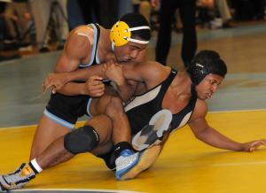 Cape's Justin Lopez gets a lock on Kevin Davis of Newark and goes on to the first-round win in the 145-pound class. BY DAN COOK