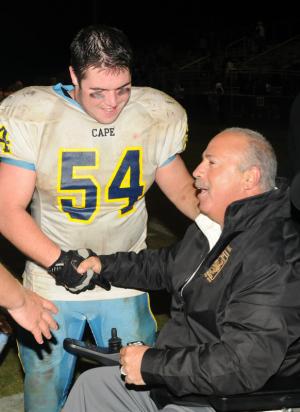 Two tough guys, Tommy Ott and Mike DeStasio, share an inspirational moment after the Sussex Tech football game. BY DAN COOK