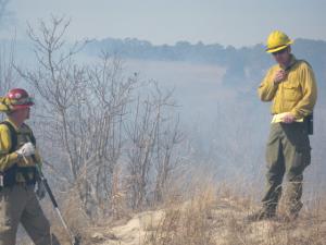 Burn Boss Erich Burkentine and Mike Sethman, both of the Delaware Forestry Service, keep an eye on the progress of the prescribed burn Monday morning. BY DENNIS FORNEY