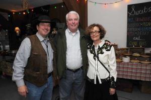 Delaware Secretary of Agriculture Ed Kee attended the event and spoke to the crowd, saying the market “Connects the farmer to the consumer.” He also said of the 17 farmers markets in Delaware, the HLFM accounts for 30 percent of the revenue. Shown with Kee are Auctioneer Dick Bryan, left, and HLFM President Helaine Harris. BY STEVEN BILLUPS