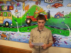 Rob Hoyle, 16, one of the 18 foster children that painted the mural, recites a rap he wrote for the unveiling. BY RYAN MAVITY