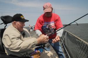 World War II POW Jack Burns gets some line help from volunteer Fred Ruff. Germans captured Burns during the Battle of the Bulge. BY STEVEN BILLUPS