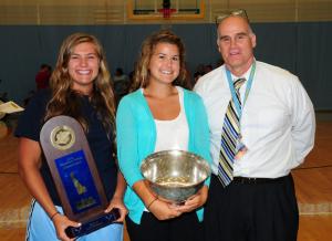 Shown with the DIAA state championship trophy are (l-r) Vikings captains Gina Voss and Jacki Coveleski with Cape Principal Brian Donahue. BY DAN COOK