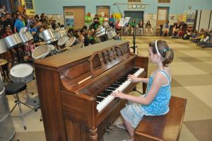 Fifth-grader Hannah Wiswell entertains students and parents on the piano. BY RON MACARTHUR