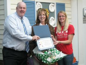 Sen. Joe Booth, center, presents a certificate to Child Development Center teachers. Shown with Booth are program director Laurie Beauchamp, center, and preschool teacher Gwen Passwaters. BY RACHEL SWICK MAVITY