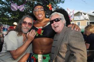Making his way through the crowd collecting tips is Wayne Gooch in a bra titled “La Vie En Rose” sponsored by Maggio Shields. With Gooch are Guillermo Silveira, left, and cancer survivor Gil Shisler. BY STEVEN BILLUPS