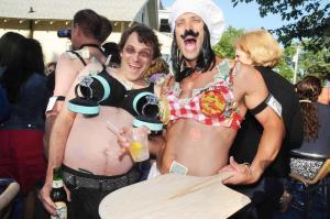 Coldwell Banker Rentals sponsored the “Bra-Ling” bra worn by Graham Robbins, left, who is working the crowd for tips with Dan Amatt in his Schell Brothers bra themed “Alla Puttanesca.” BY STEVEN BILLUPS