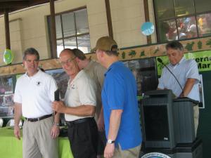 Carl Updike of Rehoboth Beach is honored for his work setting up nesting gourds for tree swallows and purple martins at the Delaware Seashore State Park marina office. Shown with Updike, center, are (l-r) Shawn Garvin of the EPA, Sec. Collin O'Mara, Markell and David Saveikis of DNREC. BY RACHEL SWICK MAVITY