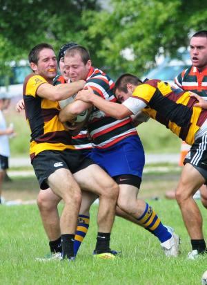 UD senior Robert Benedetto gets sandwiched by two Salisbury tacklers. BY DAN COOK