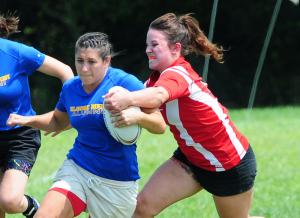 University of Delaware alumni player Katy Broadbent drags a Rams tackler in the Blue Hens' 10-7 win over West Chester. BY DAN COOK