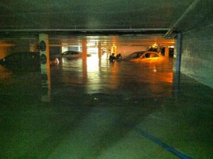 A parking garage is flooded at Brighton Suites on Wilmington Avenue. BY ELLIOT MACGUIRE