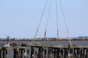 Workers give the go ahead to lift a section of pier Sept. 10. BY MELISSA STEELE