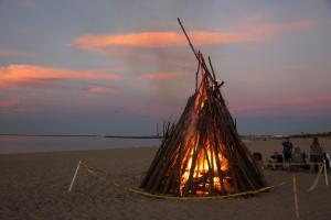 The magical colors of sunset provide an entertaining backdrop for the bonfire.