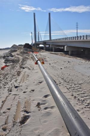 A long pipe from the northside beach near Indian River Inlet to the southside beach is the conduit for sand. BY RON MACARTHUR