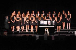 Following  the performance of the Cape Choir, the Cape Chorale took  the stage.  Shown is Chorale director Louise Foster, left, praising the  singers for  their many accomplishments over the year.