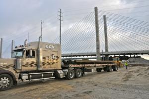 A crew begins the process of removing the steel from a trailer. BY RON MACARTHUR