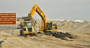 Work continues on removing the road bed for the old bridge and also rebuilding the beach north of the Indian River Inlet. BY RON MACARTHUR