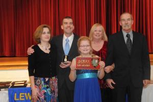 Deputy Chief Gordon Davis, surrounded by his family, holds a gold watch presented to him for his 20 years of service. Shown are (l-r) Carrie, Gordon, Autumn, Joan and Chip Davis. BY STEVEN BILLUPS