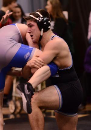 Cape's Hunter Daley, right, grapples Woodbridge 195-pounder Damian Smith to a 14-6 major decision. BY DAN COOK