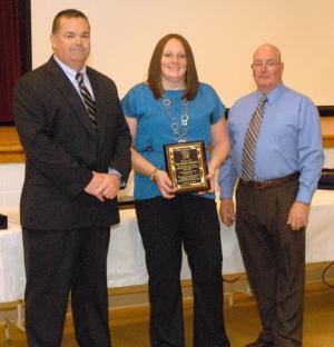 President Gary Bailey presents an appreciation plaque to the Ladies Auxiliary. Shown (l-r) are Bailey, Auxiliary President Katy Catts and Chief Harry Miller. BY WARREN JONES