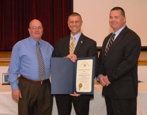 Rep. Steven Smyk, R-Milton, presents a House of Representatives Resolution to the fire company for its services during Hurricane Sandy. Shown (l-r) are Chief Harry Miller, Smyk and President Gary Bailey. BY WARREN JONES
