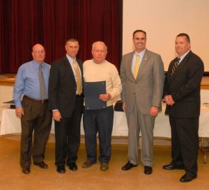 Dennard F. Quillen Jr. receives his 60-year membership citation. Shown (l-r) are Chief Harry Miller; Rep. Steven Smyk, R-Milton; Dennard Quillen; Sen. Ernie Lopez, R-Lewes; and President Gary Bailey. BY WARREN JONES
