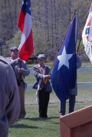 Chris Lewis holds the Bonnie Blue Flag next to John Sullivan as a member of the Color Guard.