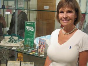 Former Summer House owner Sue Krick stands next to memorabilia on display at the Rehoboth Beach Museum. Krick owned the Summer House from 1984 to 2005. BY RYAN MAVITY