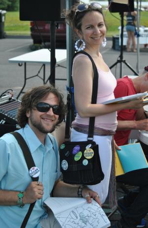 Nathaniel Corn and Rissa Miller of Baltimore show off their vegan buttons and cookbook signed by John Schlimm. PHOTOS BY LEXI COON