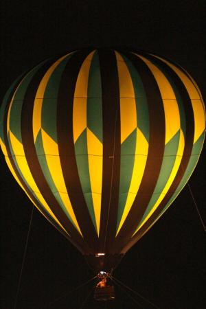 A hot air balloon glows at Firefly. BY DAREN CRISWELL