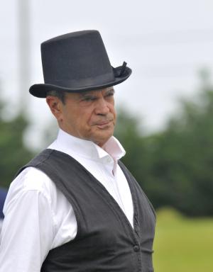 Umpire Mike Read stands beside the batter and not behind him. BY RON MACARTHUR