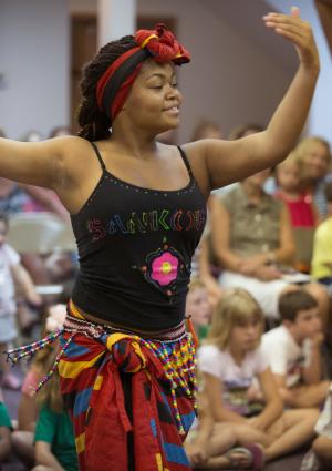 Cynthia Wharton, 17, is all smiles during a dance performance sharing African culture. BY DENY HOWETH