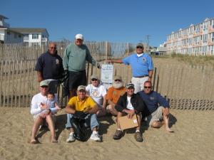 Jim May and other Adopt-A-Beach volunteers from the Dewey Beach Lions Club cleaned up an area from Collins Street to Bellevue Street in Dewey Beach, Sept. 15, 2012.Shown standing are (l-r) May, Bill Thomas and Bill Zolper.  Sitting are Wayne Steele, holding Julian; Dale Cooke; Mike Scott; Dennis Diehl; Woody Stocks; and Scott Joseph. SOURCE SUBMITTED