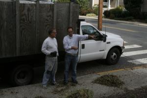 Bruce Chandler, left, and Mike DiPaolo discuss DiPaolo's idea of placing an informational display about Lewes' 100-year-old US Post Office building on the corner of the site.Chandler started a grassroots project to clear the building's existing plantings, and then plant new trees, shrubbery and flowers that would beautify the area and allow the building's architecture to be seen. DiPaolo is executive director of Lewes Historical Society. BY HENRY J. EVANS JR.