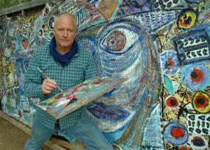 Scott Christopher is shown hard at work on a large mural in Santa Fe, N.M. SOURCE SUBMITTED