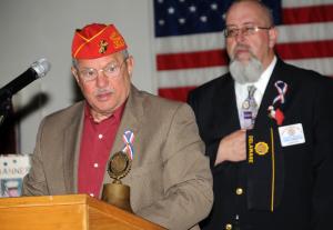 Marine veteran Austin Govin reads  the empty chair tribute of Remembrance. BY DAN COOK