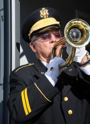 Allen Drake plays taps after the 18 gun salute. BY DAN COOK