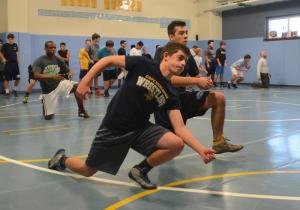 Matt Piner, left, and Joel Torres move across the mat during a penetration step warm-up. BY DAN COOK