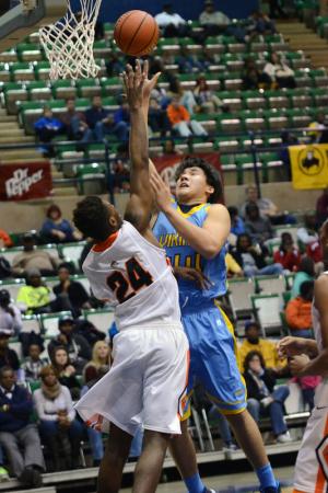 Cape forward David Kwan tips in a bucket over the Knights' John Grant for two of his 14 points in the game. BY DAN COOK