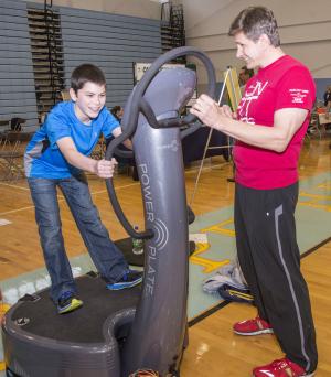 Henry Luther is instructed by Greg Mervine of Fun Fit Vibe on the use of the Power Plate. BY DENY HOWETH