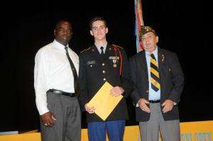 The "Woody Dively" Memorial Award for the Cadet of the Year was presented to Cadet David Collard, center, by Spencer Brittingham, left, and VFW 7447 Commander Tracy Bowen. BY STEVEN BILLUPS