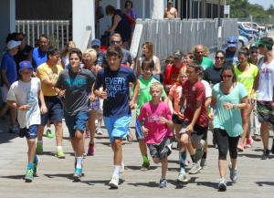 Mauria, green shirt, leads the pack as friends of all ages gathered to honor Jay Stein, who loved to run the boardwalk in the summer. BY CHRIS FLOOD
