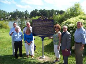 Standing at the marker are (l-r) Sen Ernie Lopez, Dan Payne, Rep. Pete Schwartzkopf, Nancy Cullen, Sallie Forman, state archivist Stephen Marz and DNREC Secretary David Small. BY RYAN MAVITY