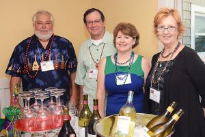 Volunteers offer cocktails to revelers, (l-r) P.D. Camenich, Bruce and Cheryl Conway, and Helen Camenich. BY DENY HOWETH