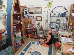 Vendor Marianne Allen is hard at work, stocking her antiques and crafts mini-store, "Treasure This" at Milton Mercantile. BY MOLLY MACMILLAN