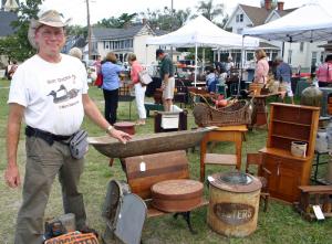 Milford resident Rob Godfrey stops for a photo with some of the antiques he was selling. BY MADDY LAURIA